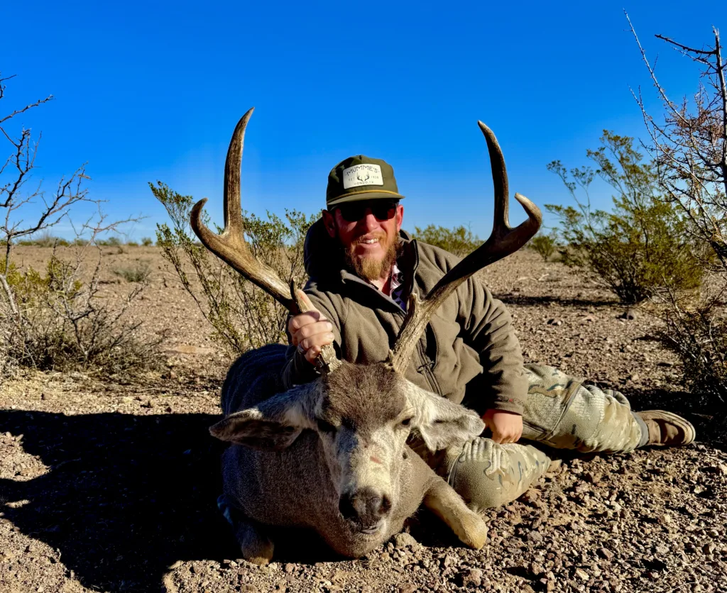 Hunter poses with his Mule Deer Harvest Ahrens Ranch and Wildlife